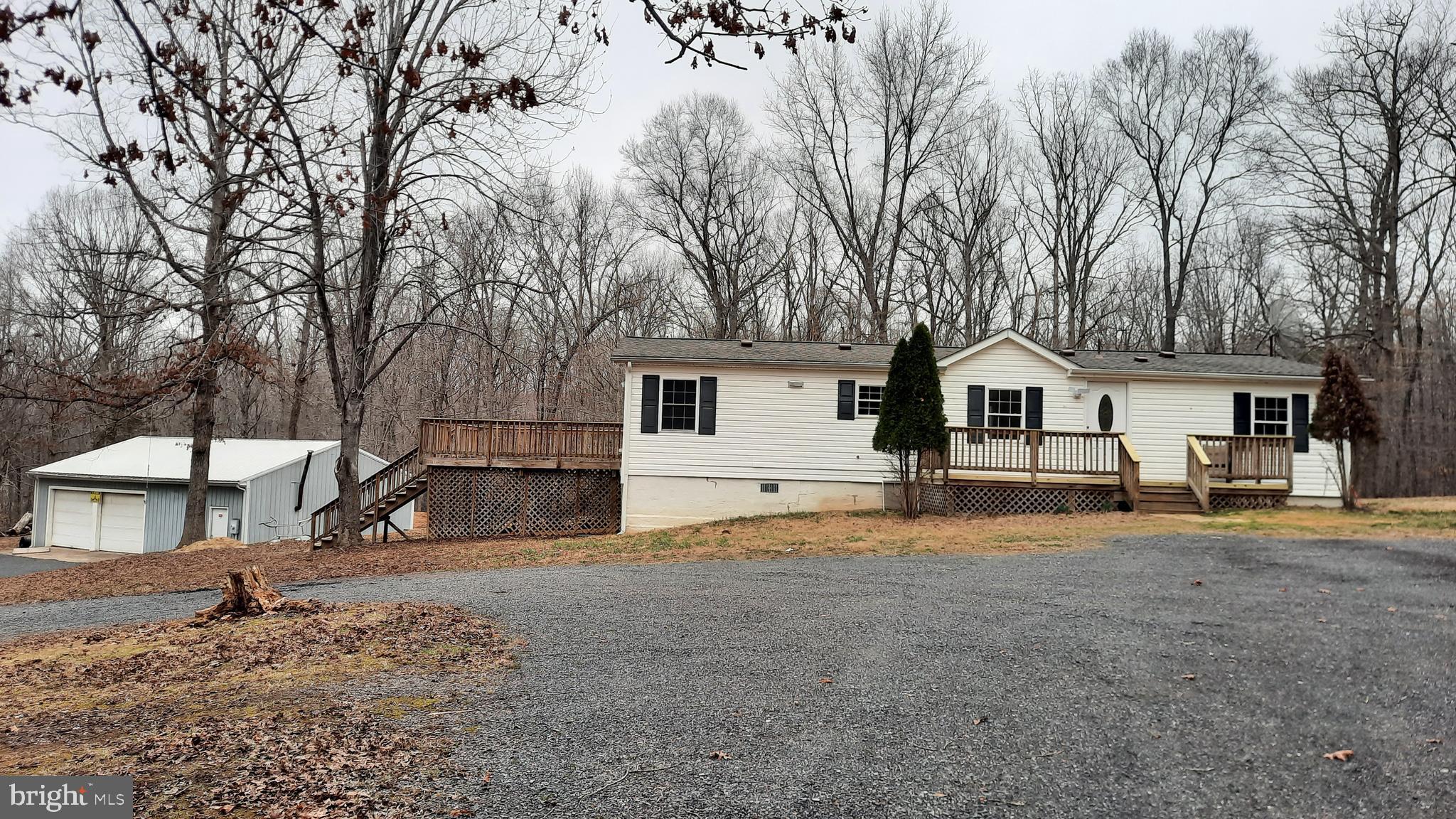 a view of a house with backyard and a tree