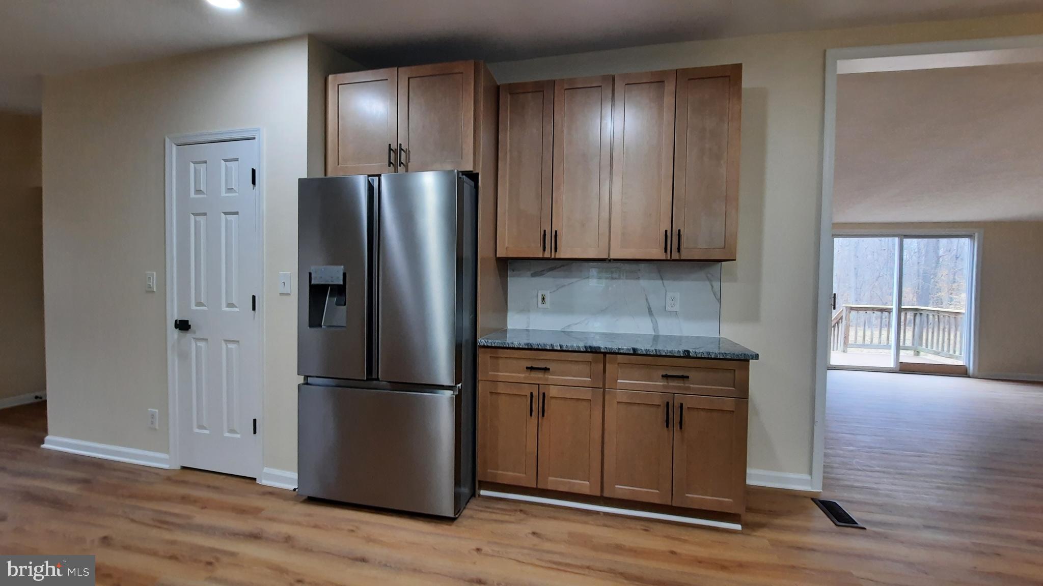 21051 Seigen Lane Richardsville, VA 22736 - Photo 13 of 42 a kitchen with stainless steel appliances granite countertop white cabinets and wooden floor
