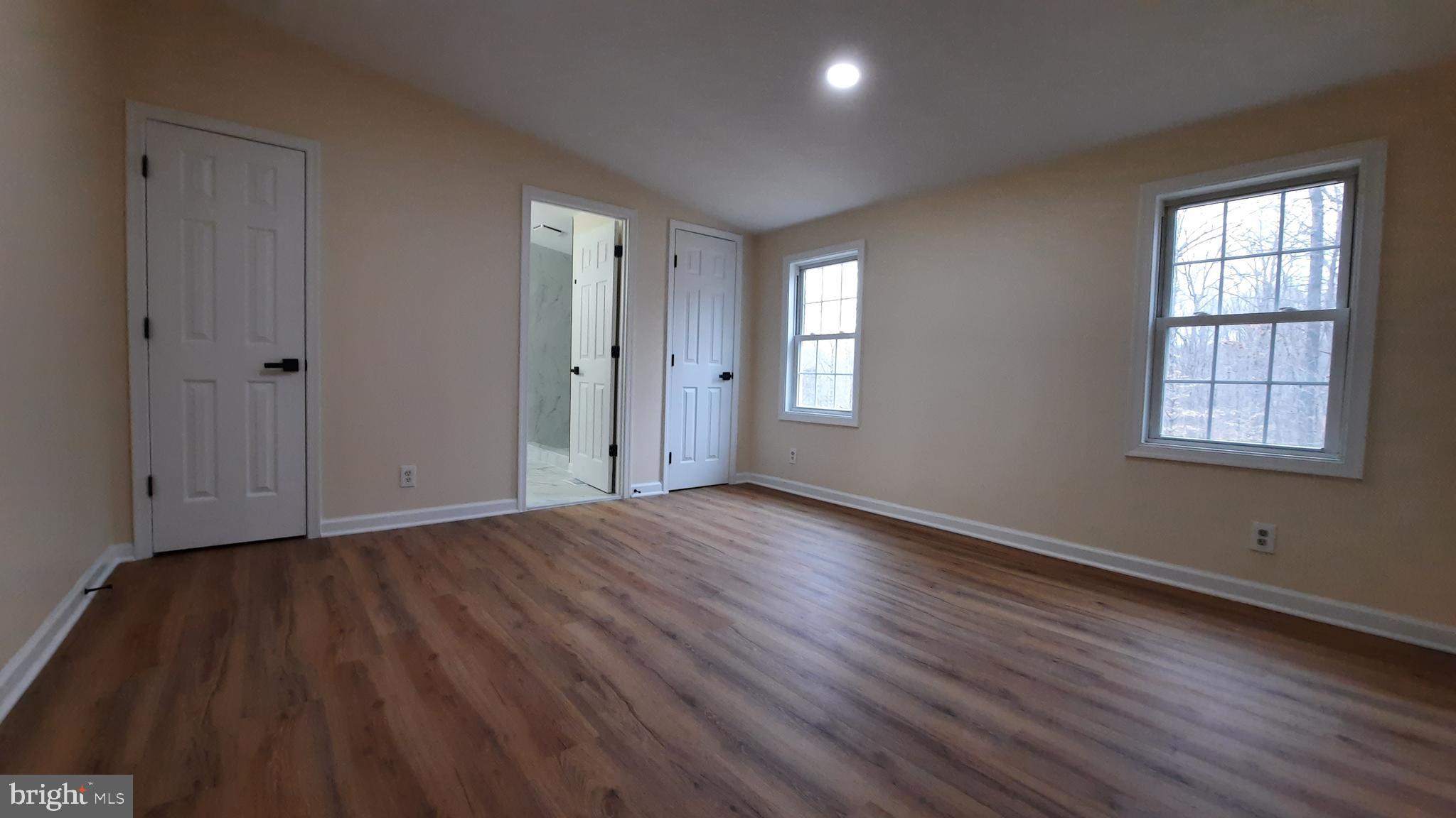 21051 Seigen Lane Richardsville, VA 22736 - Photo 16 of 42 a view of an empty room with wooden floor and a window