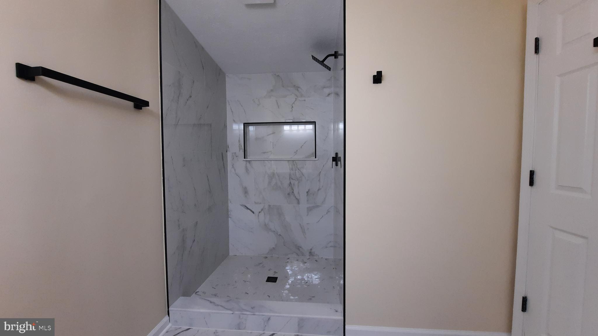 21051 Seigen Lane Richardsville, VA 22736 - Photo 18 of 42 a bathroom with a glass shower door