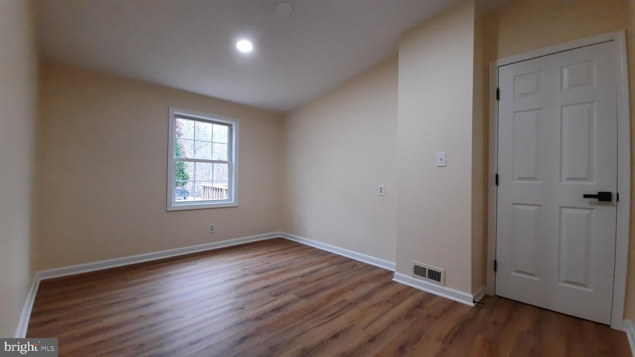 21051 Seigen Lane Richardsville, VA 22736 - Photo 19 of 42 an empty room with wooden floor and windows
