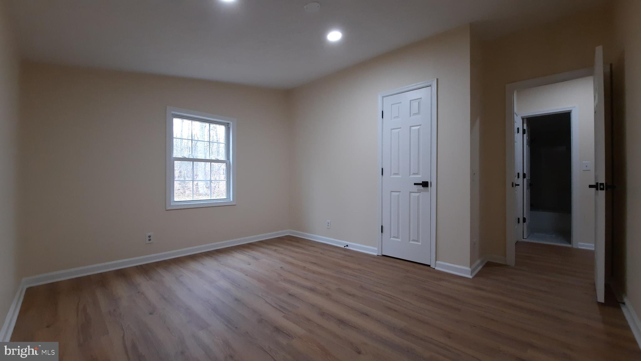 21051 Seigen Lane Richardsville, VA 22736 - Photo 20 of 42 an empty room with wooden floor and windows