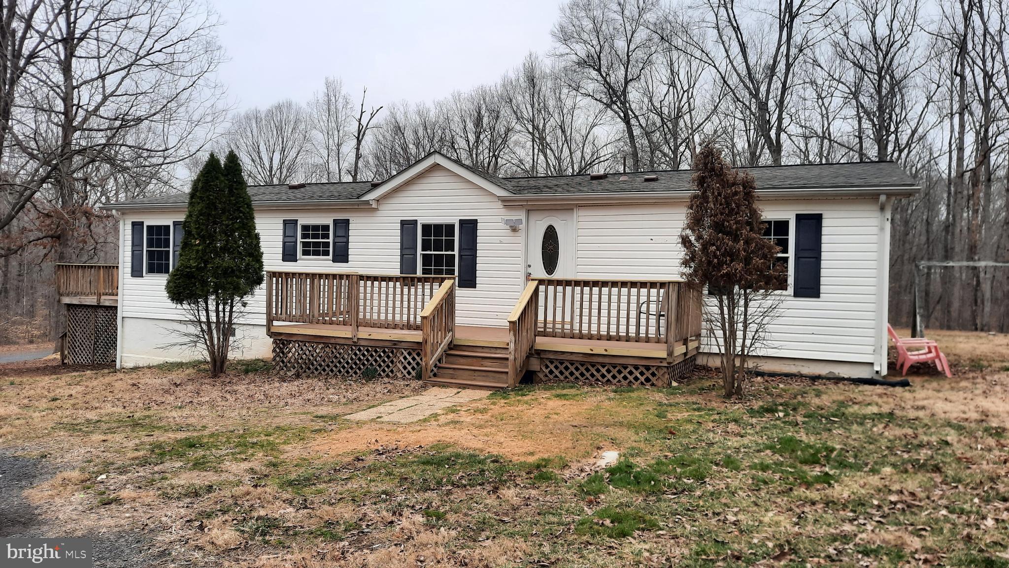 21051 Seigen Lane Richardsville, VA 22736 - Photo 30 of 42 a white house that has a small yard and a large tree