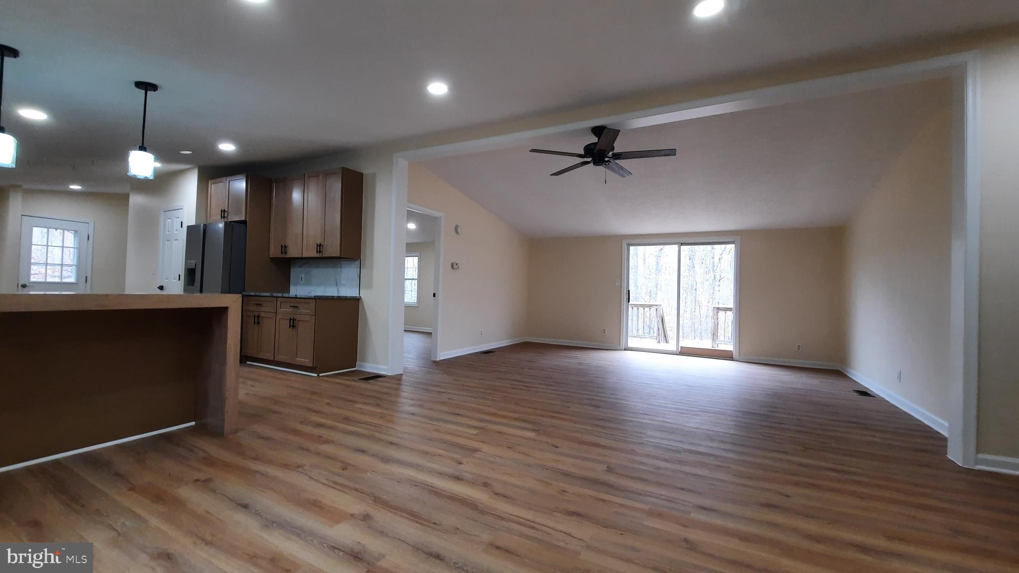 21051 Seigen Lane Richardsville, VA 22736 - Photo 4 of 42 an empty room with wooden floor and windows