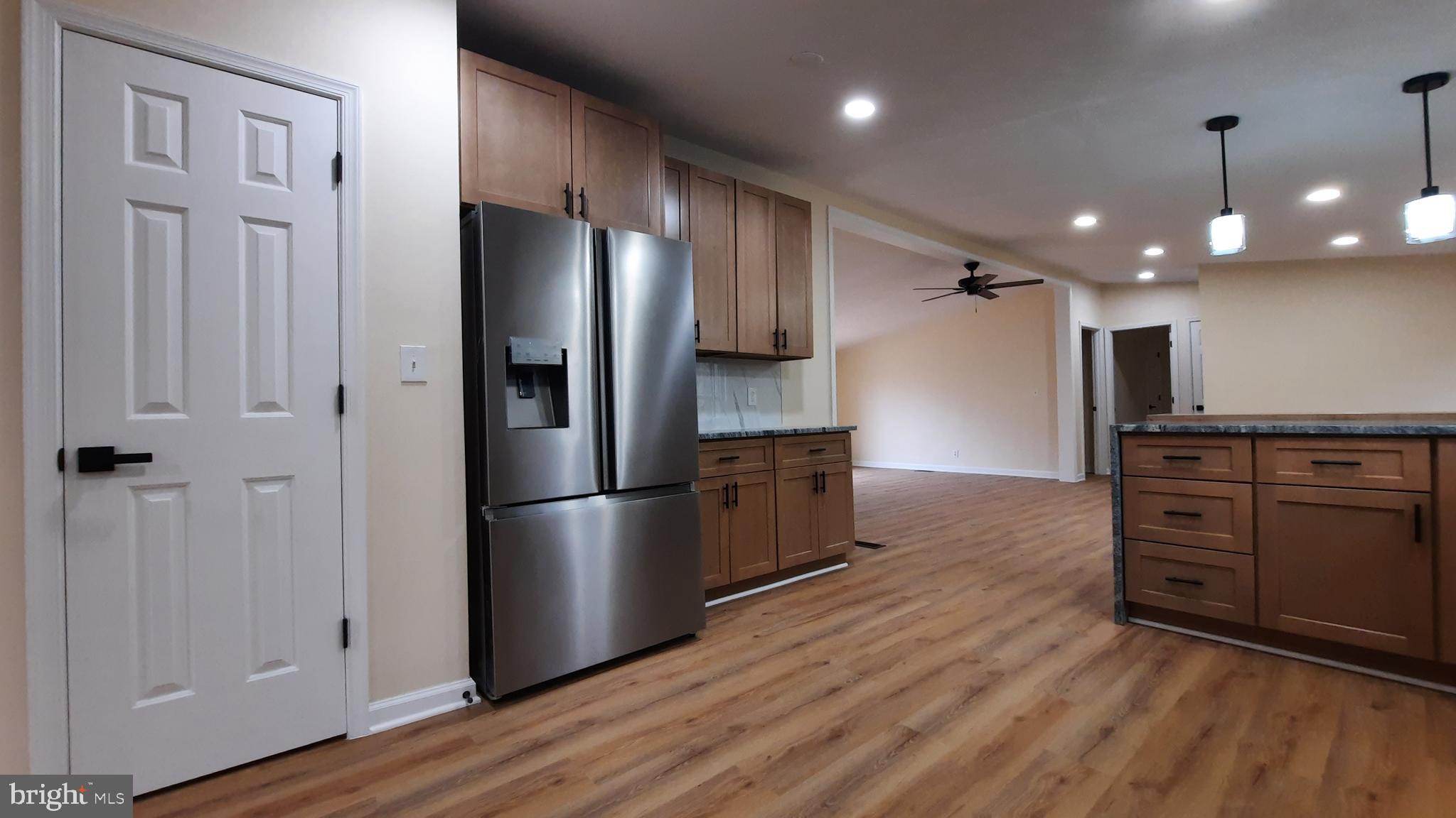 21051 Seigen Lane Richardsville, VA 22736 - Photo 8 of 42 a kitchen with stainless steel appliances a refrigerator and wooden floor