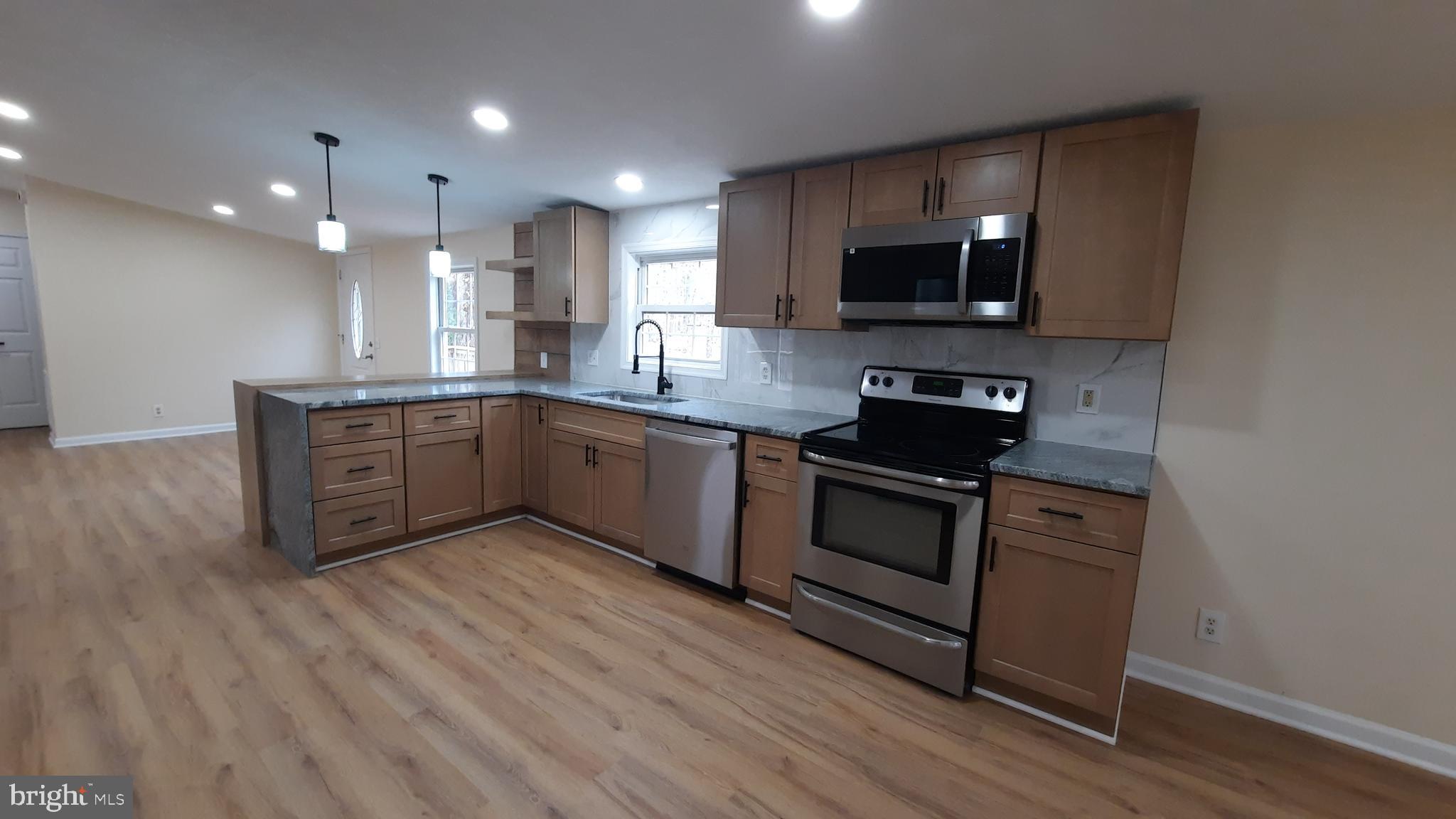 21051 Seigen Lane Richardsville, VA 22736 - Photo 9 of 42 a kitchen with stainless steel appliances granite countertop a stove a sink and a microwave