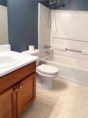 a bathroom with a toilet sink and shower