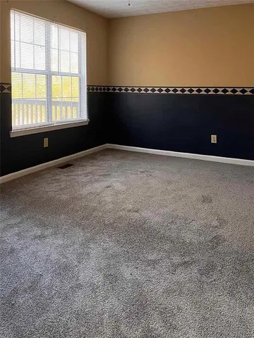 a view of an empty room and a window