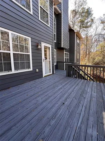 a view of a house with wooden deck