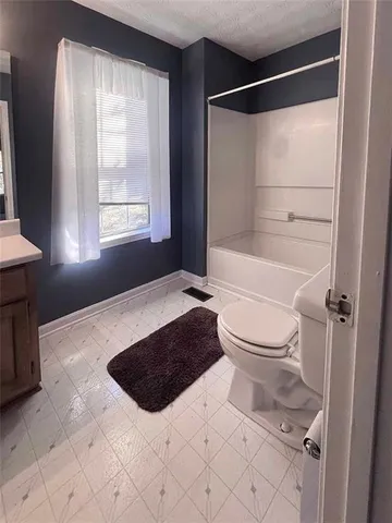 a bathroom with a toilet a sink and a shower