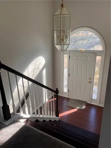 a view of hall way with wooden floor and dining room