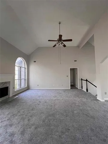 a view of empty room with a fireplace