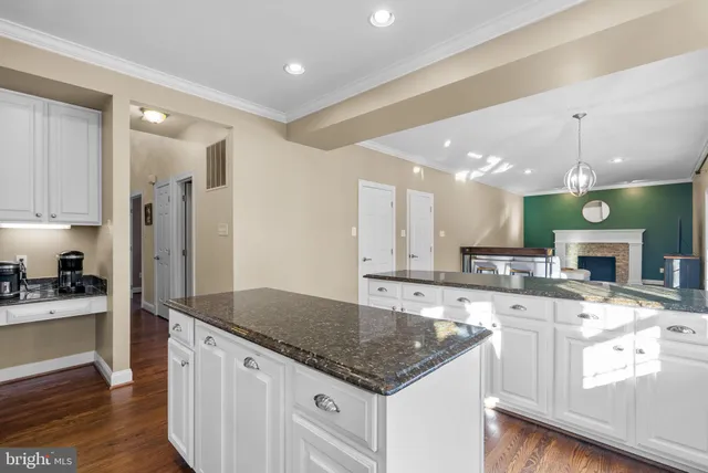 a bedroom with a large bed a flat tv screen and dresser
