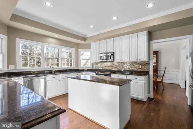 a living room with kitchen island furniture and a wooden floor