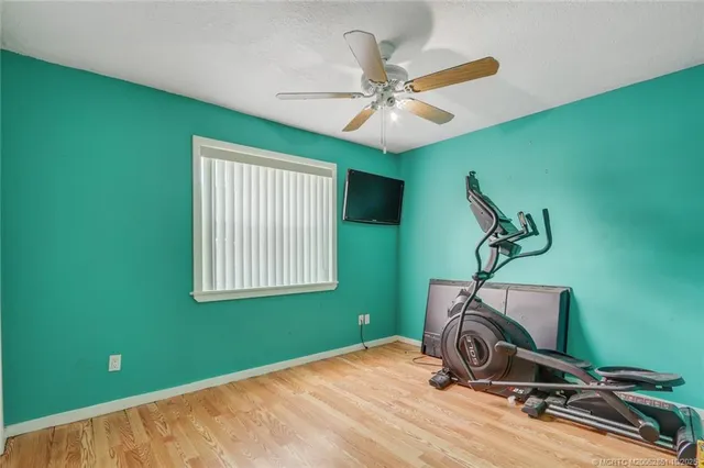 a room with gym equipment and windows