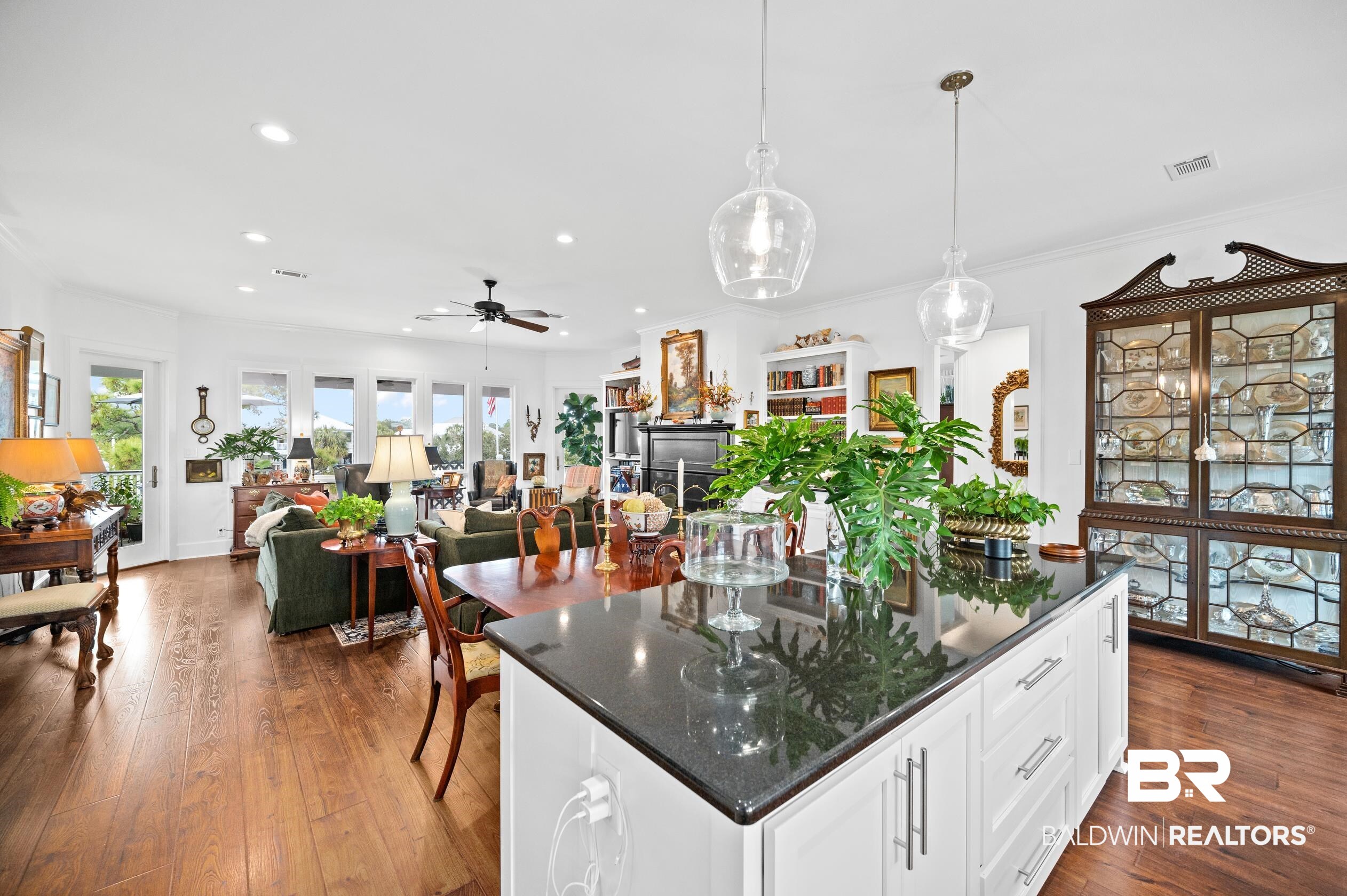 31835 River Road Orange Beach, AL 36561 - Photo 25 of 55 Kitchen with white cabinetry, hanging light fixtures, a center island, ornamental molding, and dark hardwood / wood-style flooring