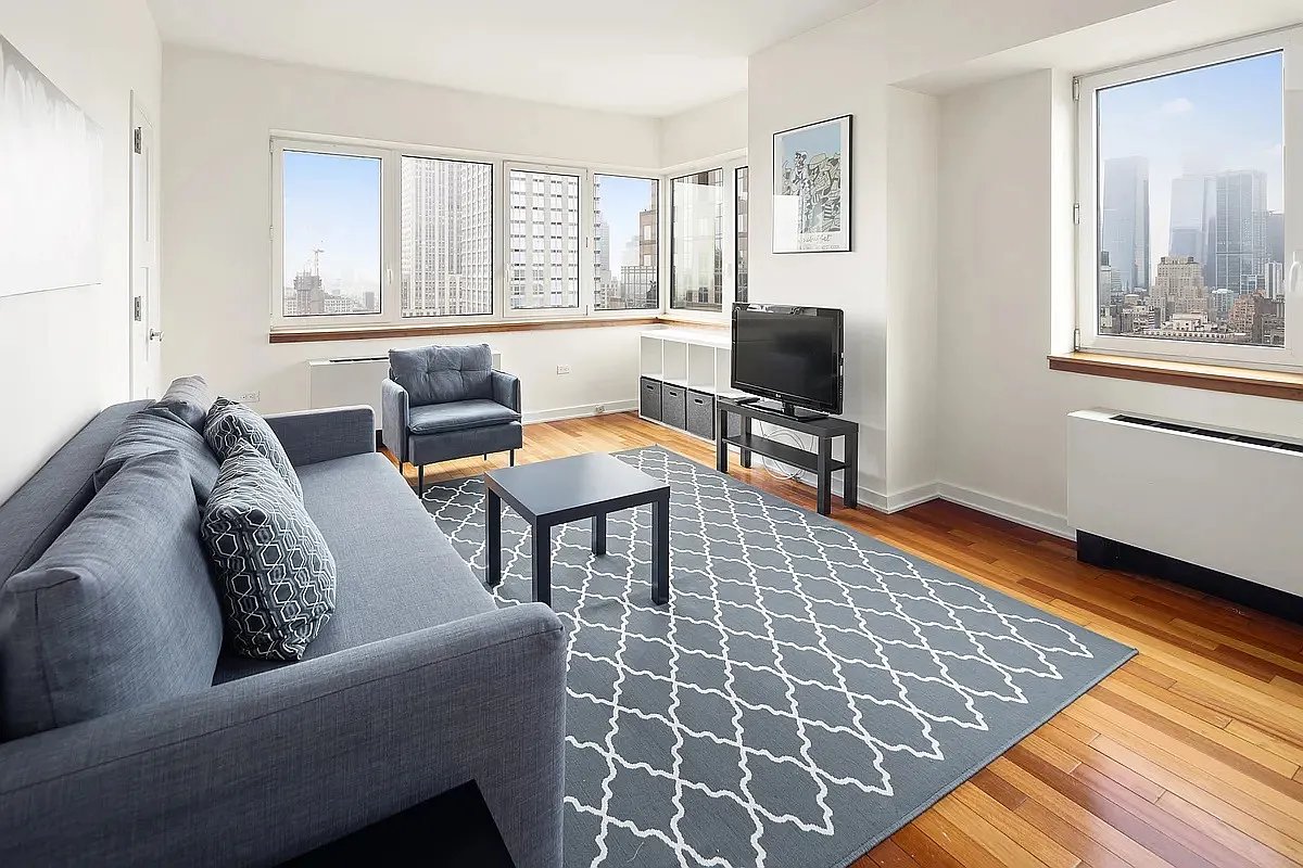 425 5th Avenue, Unit 44D Manhattan, NY 10016 - Photo 1 of 10 a living room with furniture and a window
