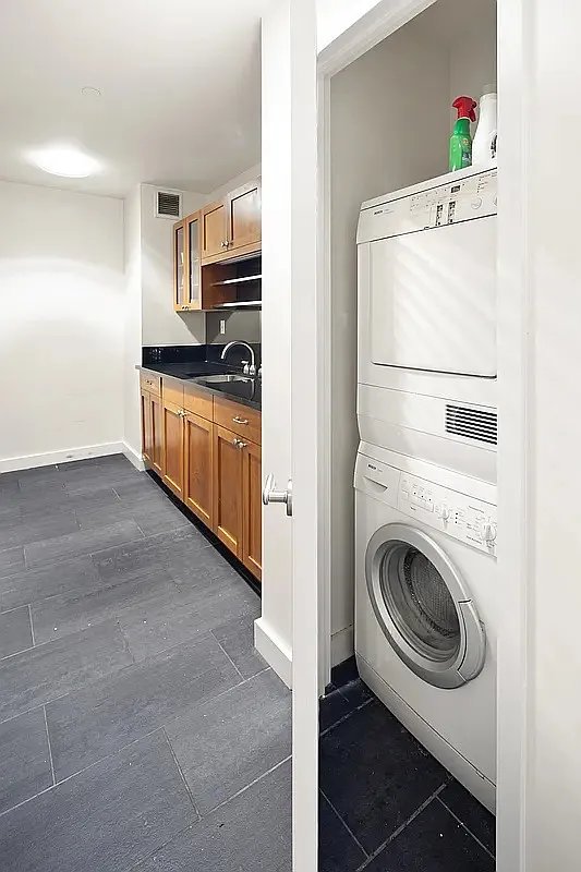 425 5th Avenue, Unit 44D Manhattan, NY 10016 - Photo 7 of 10 a kitchen with a refrigerator sink stove and cabinets