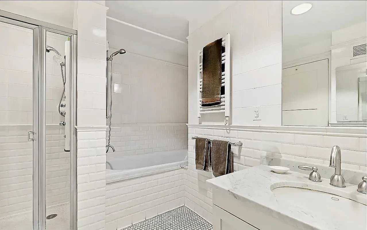 425 5th Avenue, Unit 44D Manhattan, NY 10016 - Photo 8 of 10 a bathroom with a tub sink shower and mirror