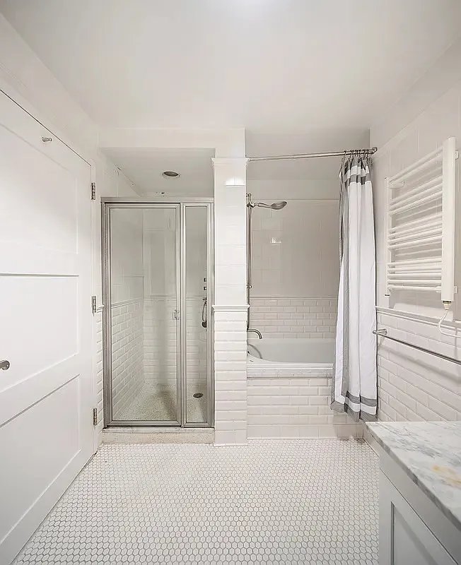 425 5th Avenue, Unit 44D Manhattan, NY 10016 - Photo 9 of 10 a bathroom with a shower and a tub
