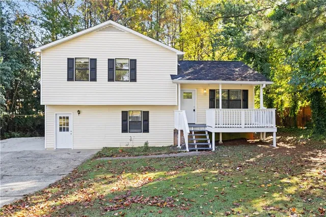 a view of house and yard with swimming pool