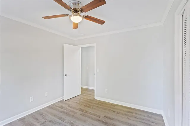 an empty room with a fan and a fan