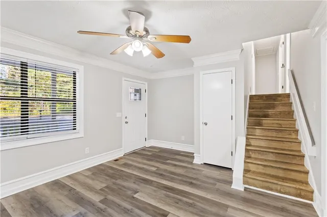 a view of a livingroom with wooden floor and window