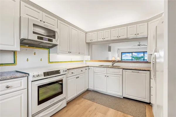 a kitchen with stainless steel appliances granite countertop a sink and cabinets