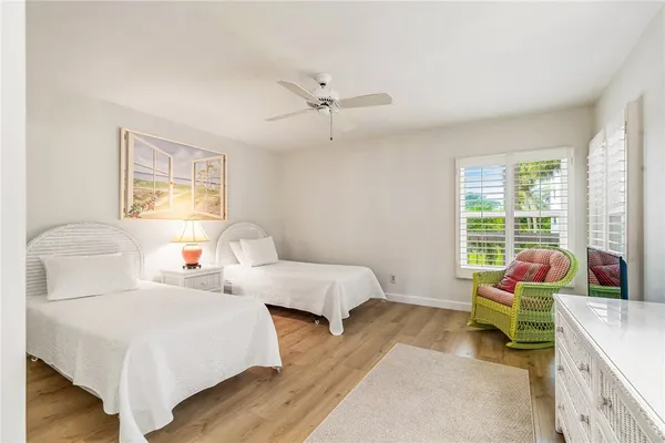 a bedroom with two beds and a chandelier