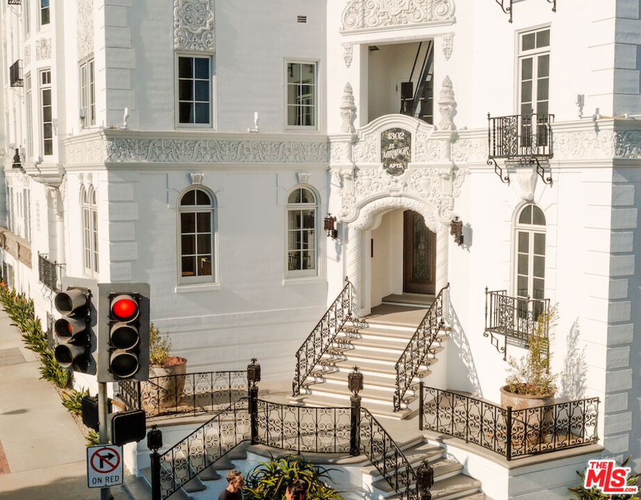 1302 North Sweetzer Avenue, Unit 402 West Hollywood, CA 90069 - Photo 18 of 23 a front view of a building with many windows