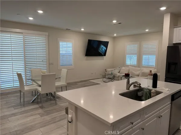 a kitchen with a sink cabinets and wooden floor