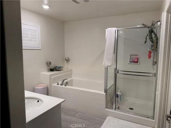 a bathroom with a bathtub and a shower