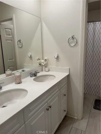 a bathroom with a double vanity sink and mirror