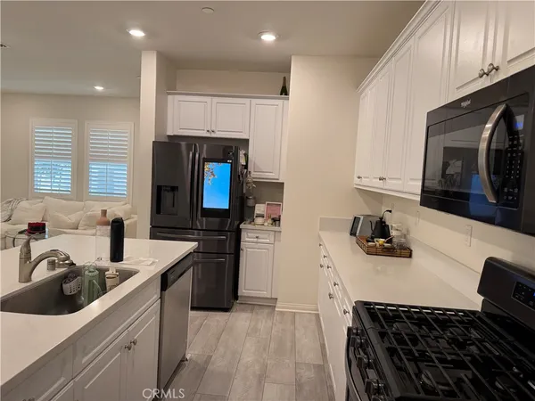 a kitchen with a sink stove top oven and refrigerator