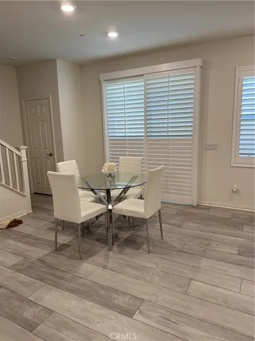 a view of a work space with wooden floor and furniture