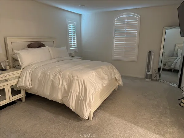 a bedroom with a bed and a chair