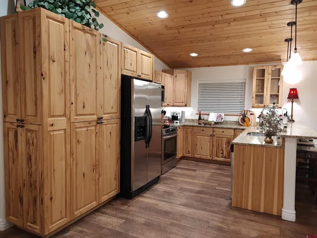 a kitchen with stainless steel appliances a refrigerator and a stove