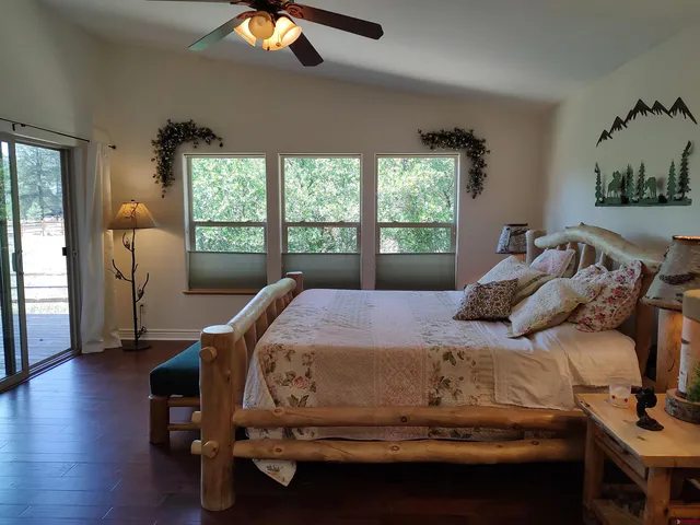 a bedroom with furniture and a wooden floor