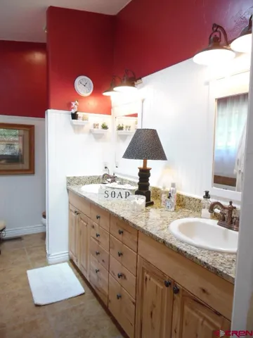a bathroom with a sink a toilet and a shower curtain
