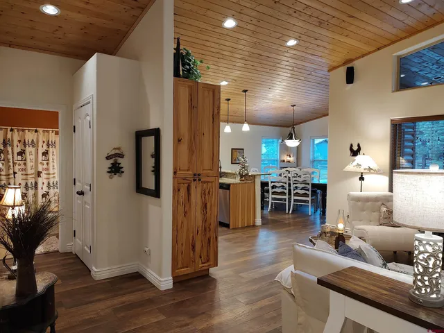 a living room with furniture kitchen view and a fireplace