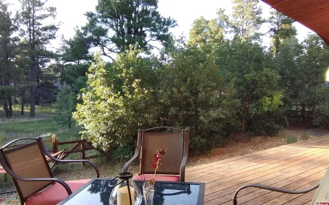 a backyard of a house with table and chairs