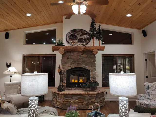 a living room with furniture a fireplace and a chandelier