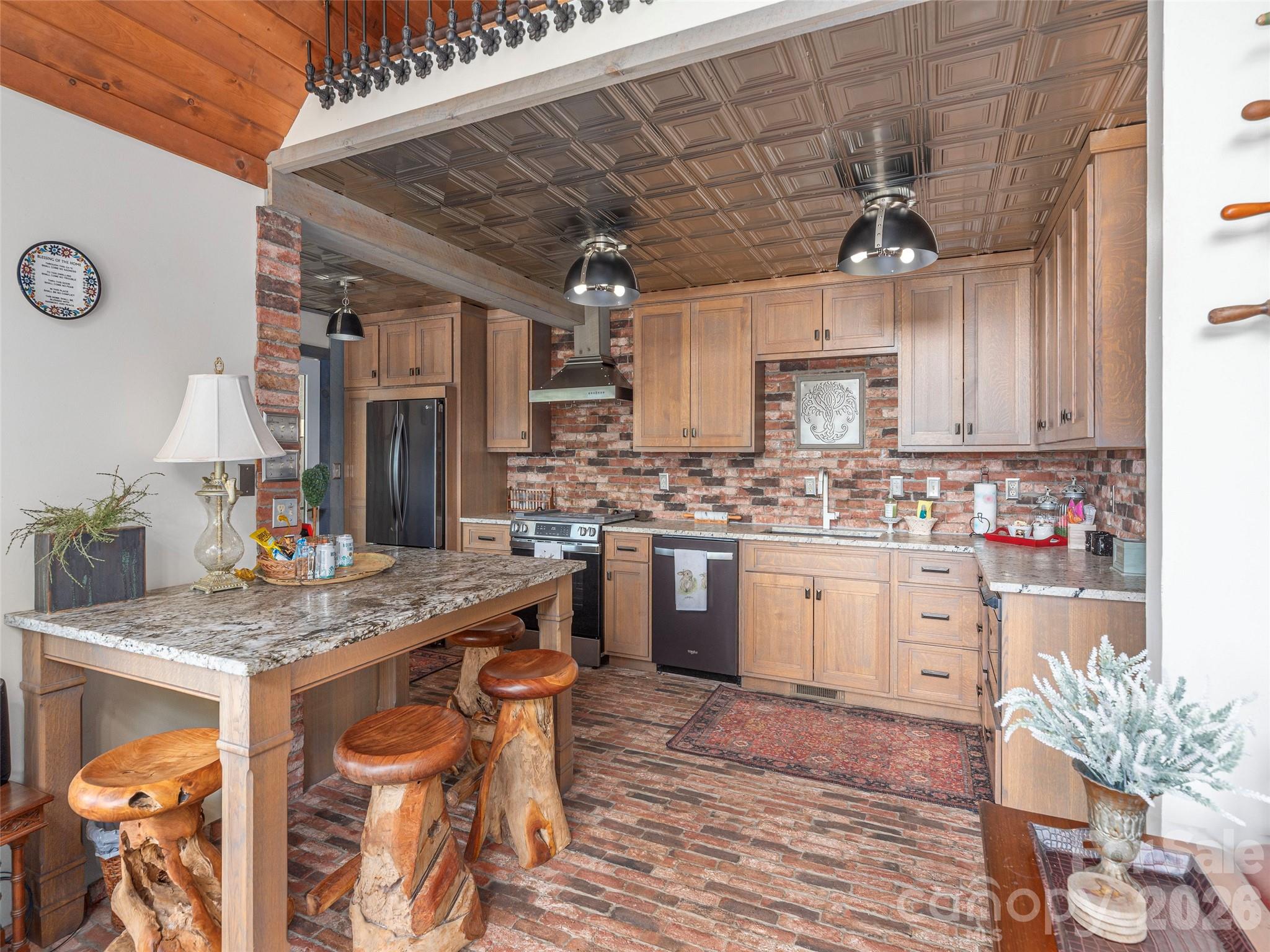 461 Ferguson Cove Loop Clyde, NC 28721 - Photo 12 of 46 a kitchen with a table chairs cabinets and appliances