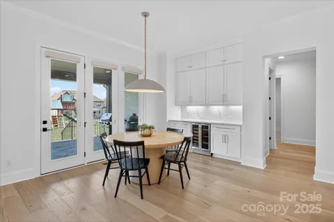 a view of a dining room with furniture and a chandelier
