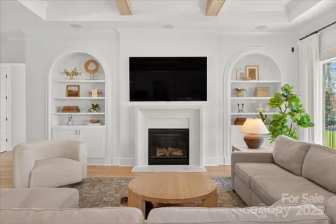 a living room with furniture fireplace and window