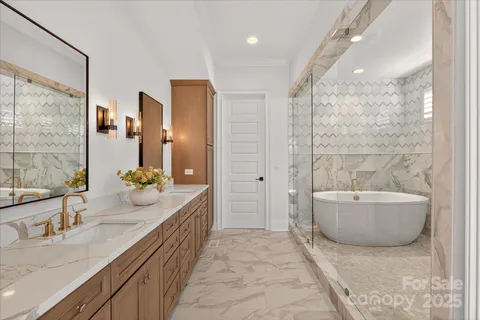 a spacious bathroom with a tub sink and mirror