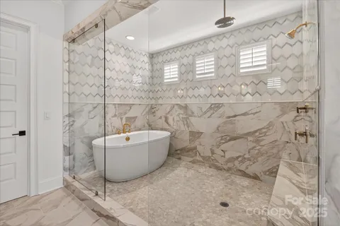 a bathroom with a bathtub and shower