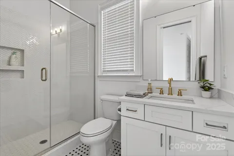 a bathroom with a sink toilet and shower