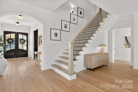 a view of entryway and hall with wooden floor