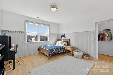 a bedroom with two beds and a window